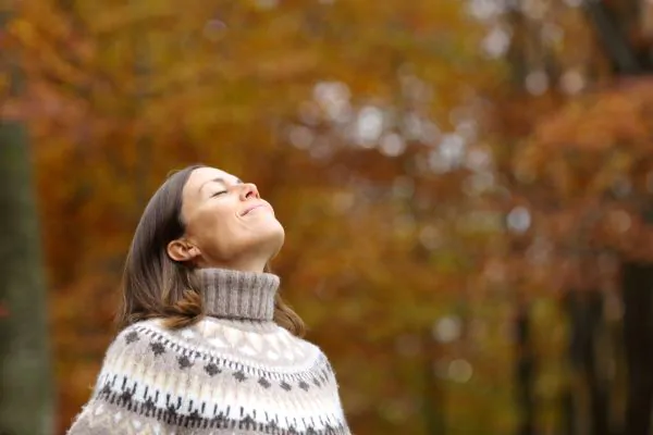 Woman taking breathe with fresh air